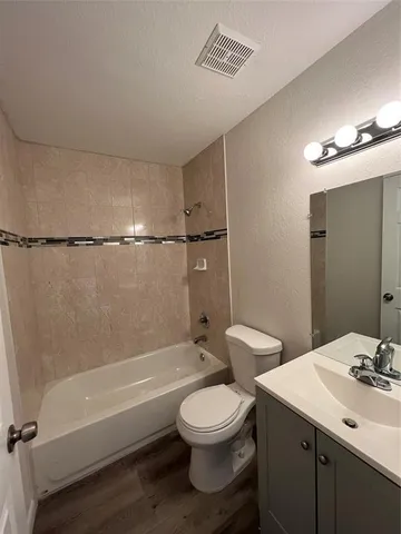a bathroom with a toilet a sink and bathtub