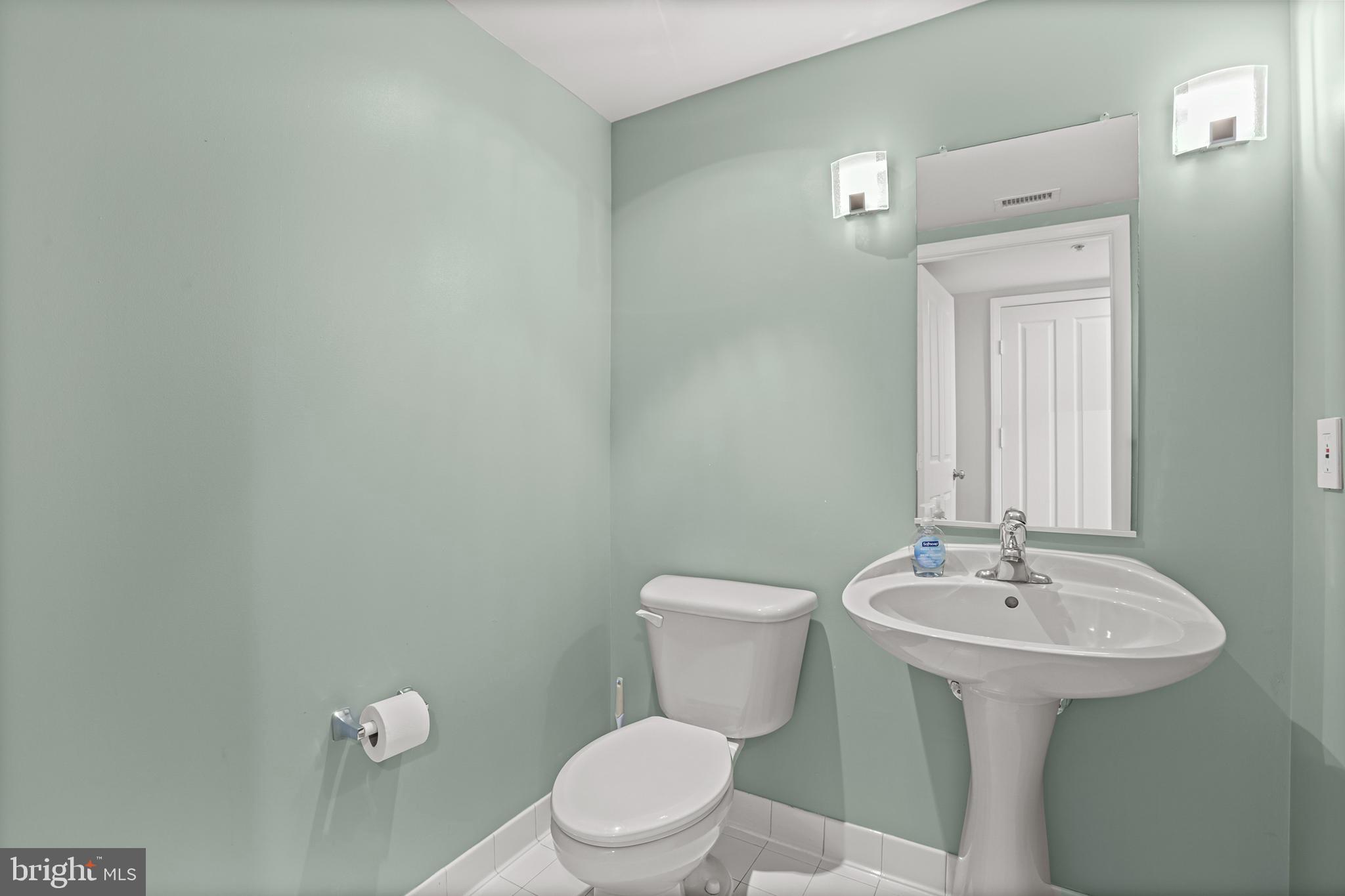 1220 North Fillmore Street, Unit 602 Arlington, VA 22201 - Photo 16 of 43 a bathroom with a sink mirror and toilet