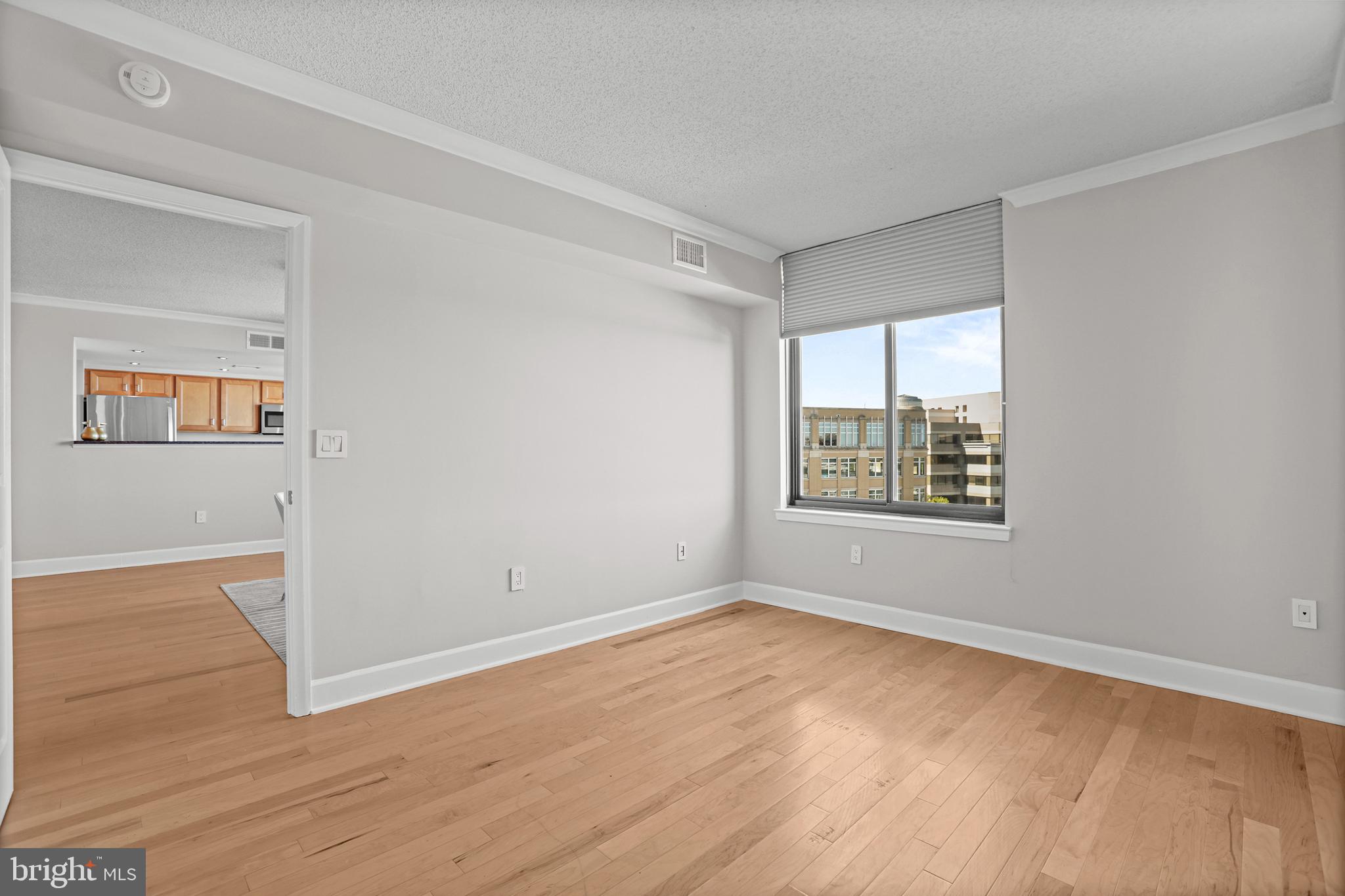 1220 North Fillmore Street, Unit 602 Arlington, VA 22201 - Photo 22 of 43 a view of an empty room with wooden floor and a window