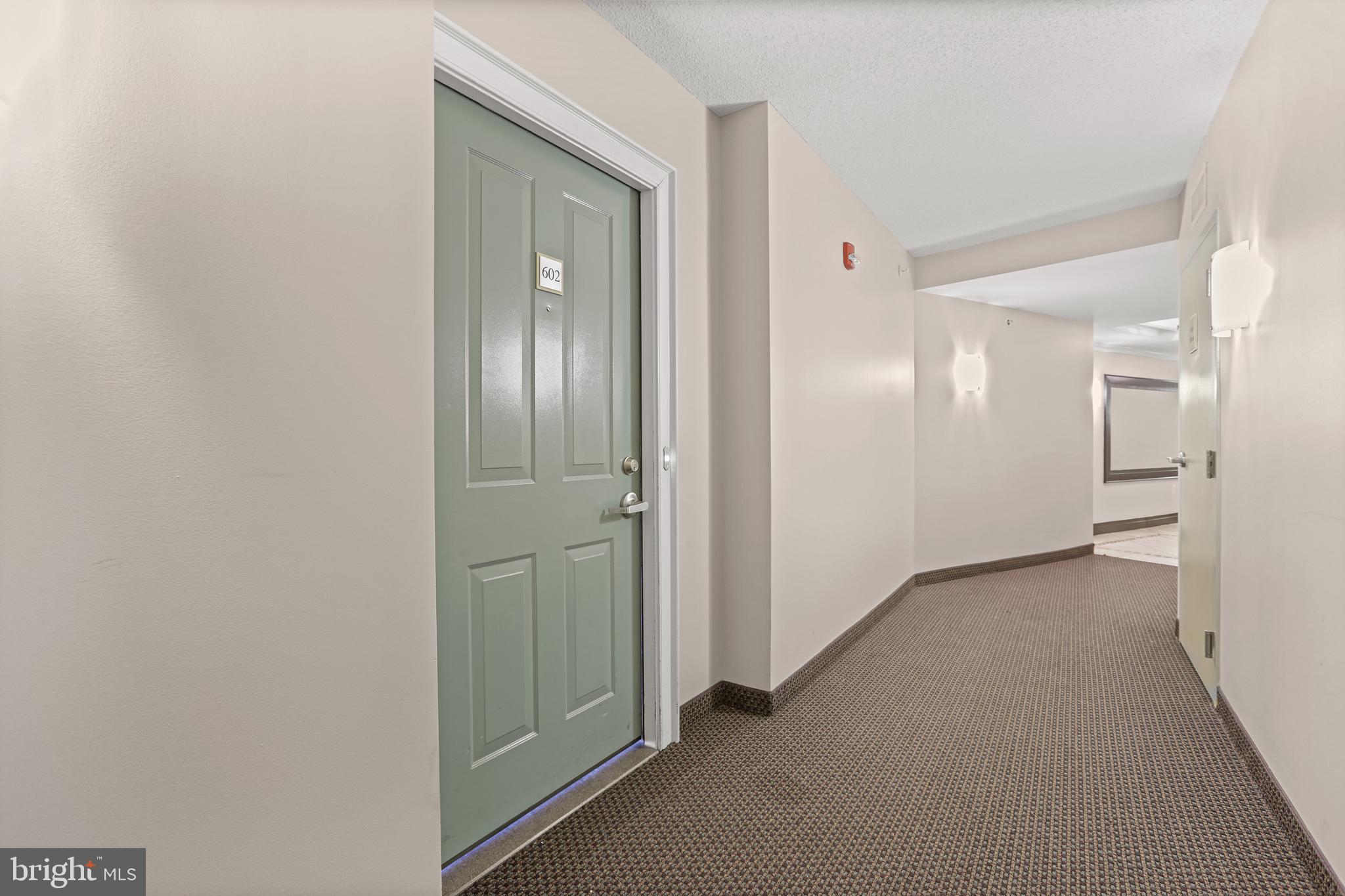 1220 North Fillmore Street, Unit 602 Arlington, VA 22201 - Photo 26 of 43 a view of a hallway with wooden shelves