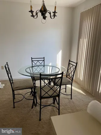 a view of a dining room with furniture and a window