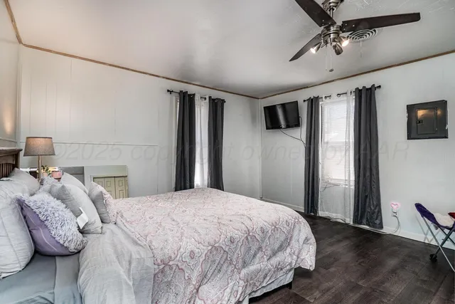 a bedroom with a bed next to a window with the view of bedroom