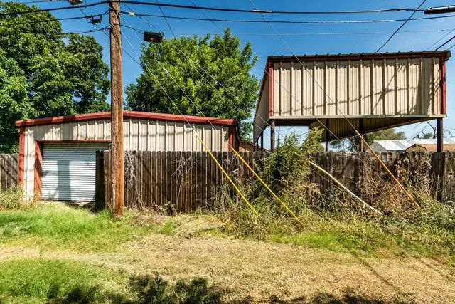 a view of a house with large windows and a yard