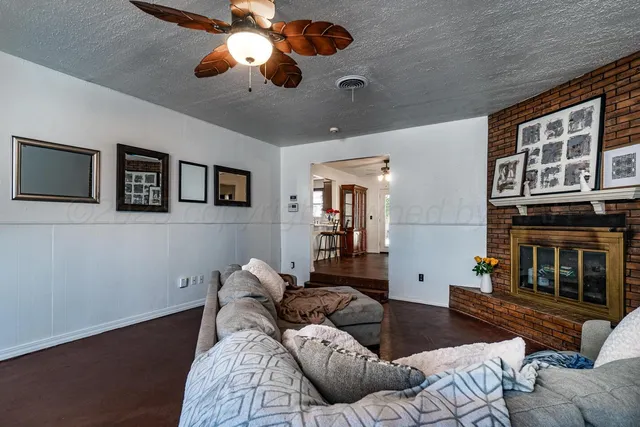 a living room with furniture and a fireplace