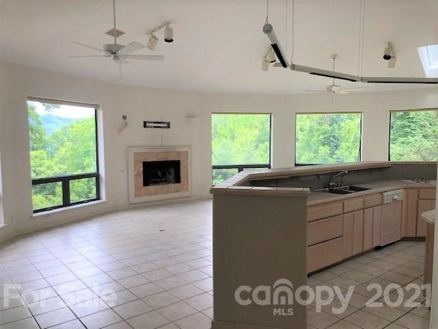 387 Spring Cove Road Waynesville, NC 28786 - Photo 14 of 48 a kitchen with stainless steel appliances granite countertop a stove a sink and a microwave