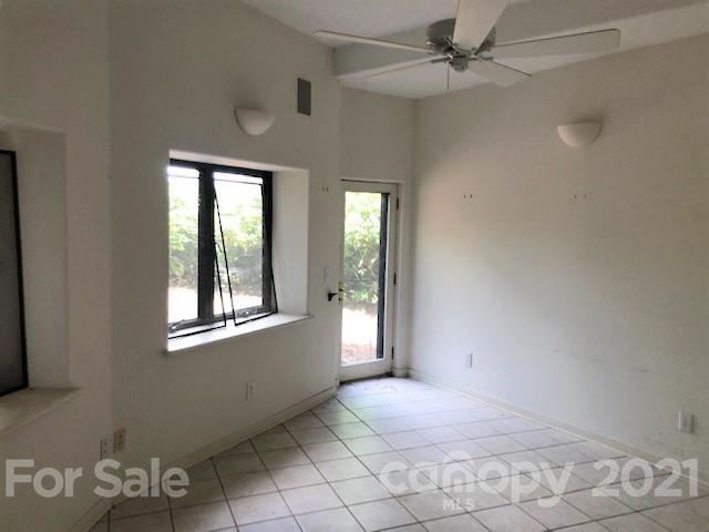 387 Spring Cove Road Waynesville, NC 28786 - Photo 22 of 48 an empty room with windows and fan
