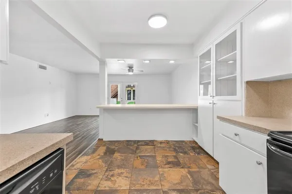 a view of a kitchen with sink and cabinets