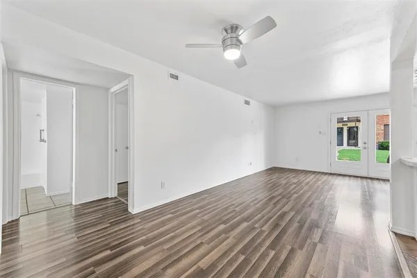 wooden floor in an empty room with a window