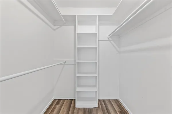 a view of walk in closet with empty racks