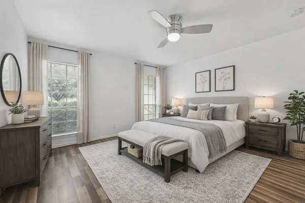 a spacious bedroom with a bed and a chandelier