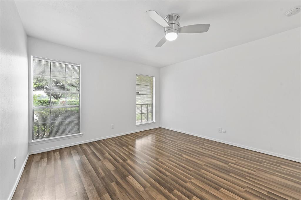 4002 Ridglea Country Club Drive Fort Worth, TX 76126 - Photo 22 of 36 an empty room with wooden floor fan and windows