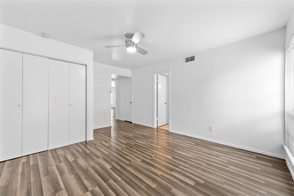 4002 Ridglea Country Club Drive Fort Worth, TX 76126 - Photo 23 of 36 an empty room with wooden floor and windows