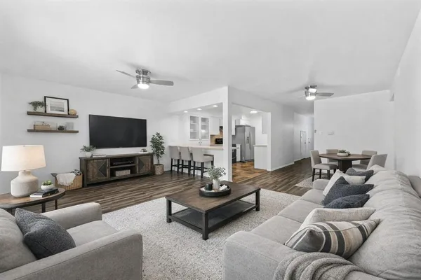 a living room with furniture a flat screen tv and a fireplace