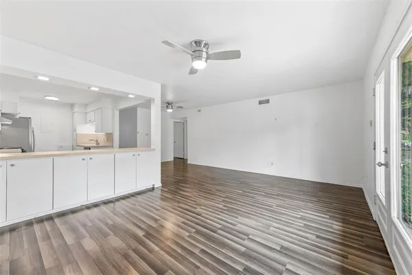 a view of a kitchen with wooden floor and a kitchen