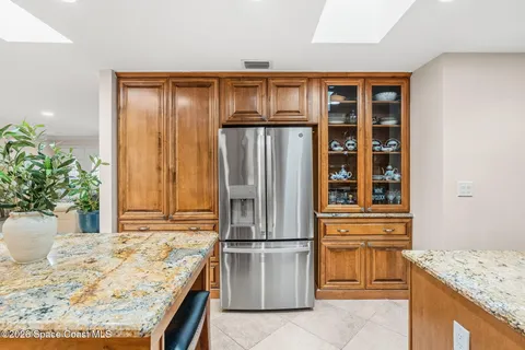 a view of a dining room with furniture a chandelier and a rug