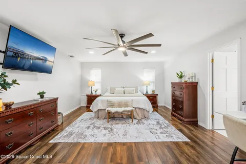 a bathroom with a granite countertop toilet a sink and a mirror