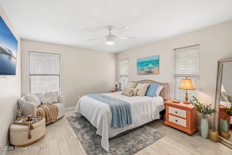 an aerial view of residential houses with outdoor space and trees