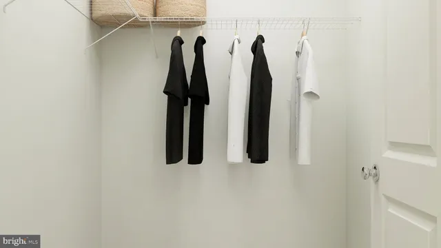 a view of walk in closet with clothes