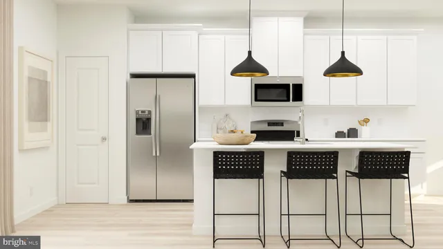 a kitchen with stainless steel appliances granite countertop a refrigerator a stove a microwave oven a sink and dishwasher