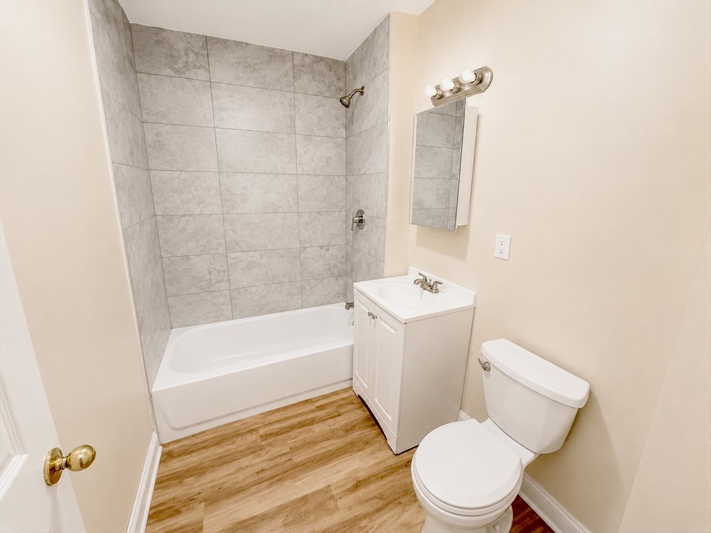 19 Dunlap Street, Unit 1 Boston, MA 02124 - Photo 7 of 9 a white toilet sitting next to a bath tub