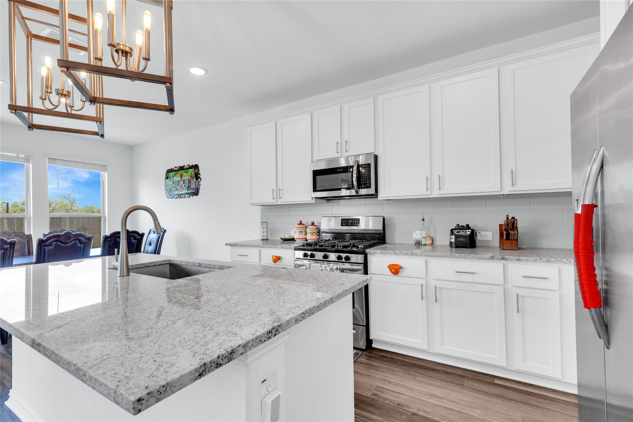 122 Shagbark Trail Bastrop, TX 78602 - Photo 14 of 36 a kitchen with stainless steel appliances granite countertop a sink a stove and cabinets
