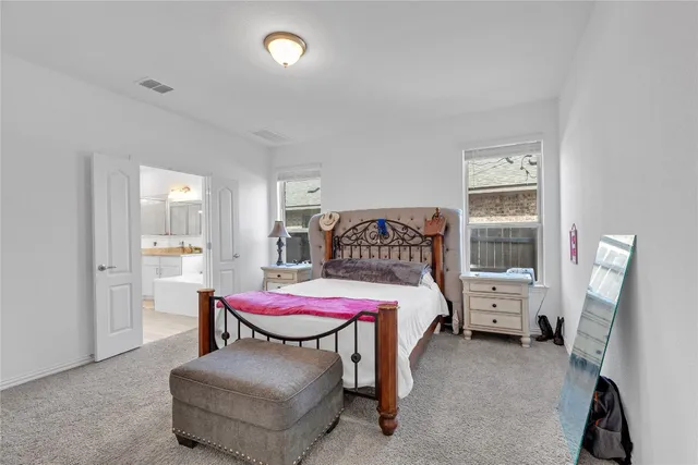 a bedroom with a bed and a chair