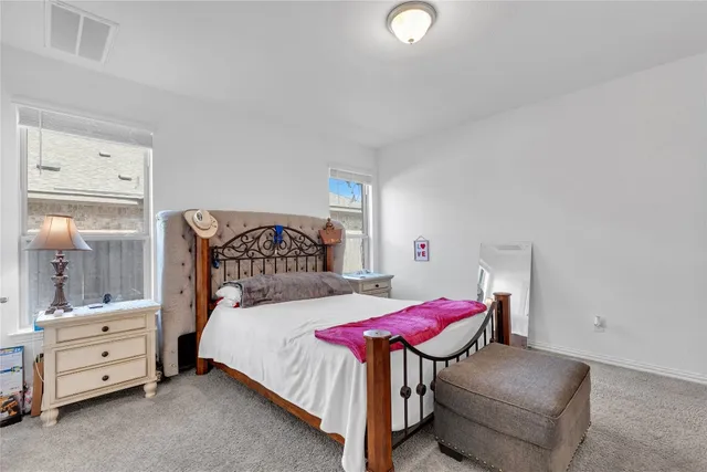 a bedroom with a bed and a dresser