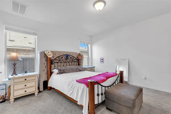 a bedroom with a bed and a chair