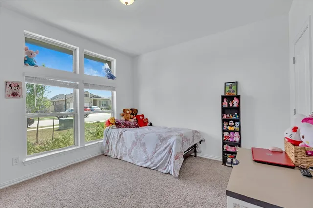 a living room with a bed and a window