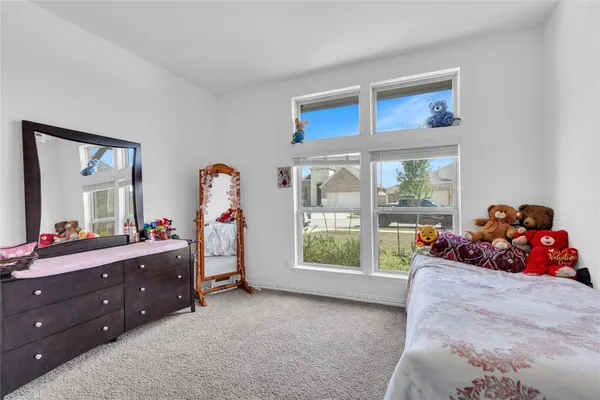 a living room with a bed and a window