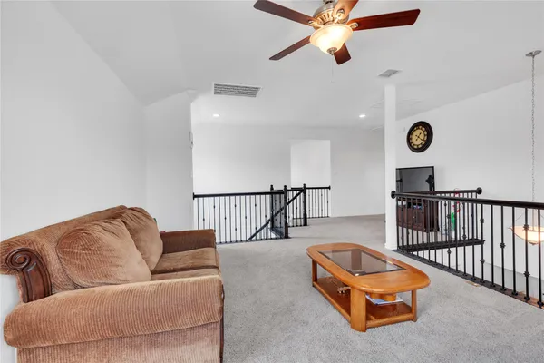 a living room with furniture a couch and a chandelier