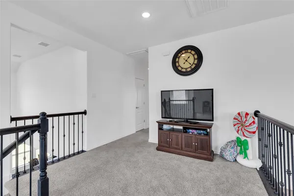 a living room with furniture ceiling fan and a rug