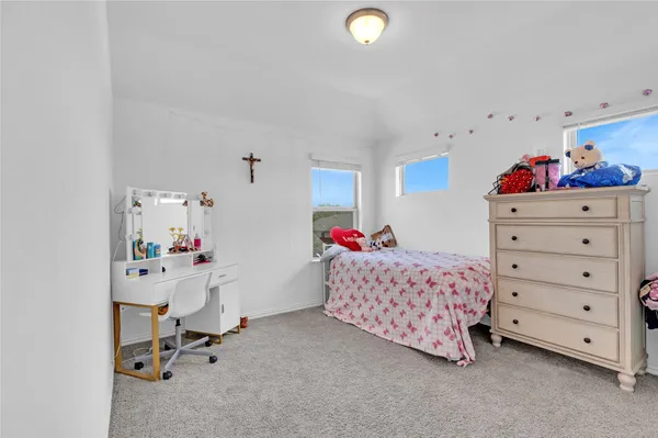a bedroom with a bed and cabinets