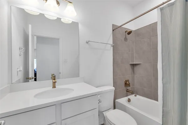 a bathroom with a sink toilet tub and shower