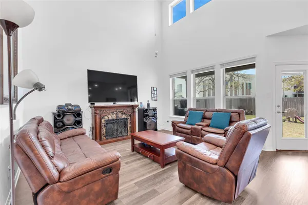 a living room with furniture a fireplace and a flat screen tv