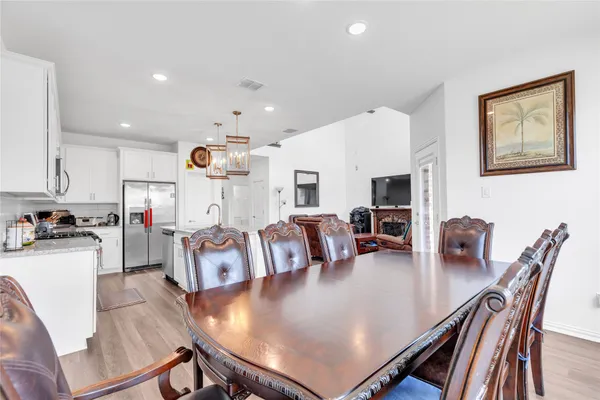 a living room with kitchen island furniture and a view of kitchen