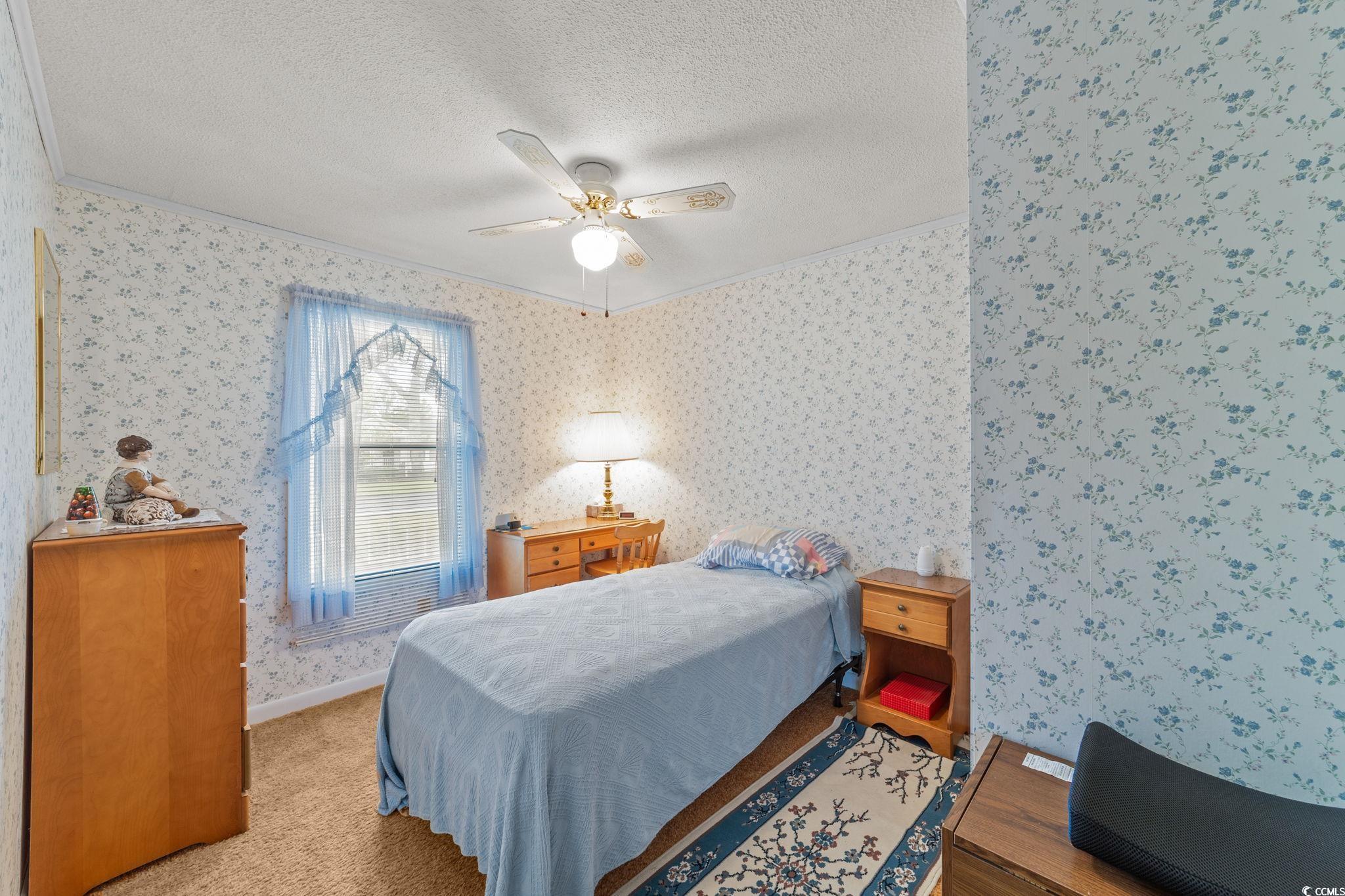 894 South Marlin Circle Murrells Inlet, SC 29576 - Photo 16 of 40 Carpeted bedroom featuring crown molding, ceiling fan, and a textured ceiling