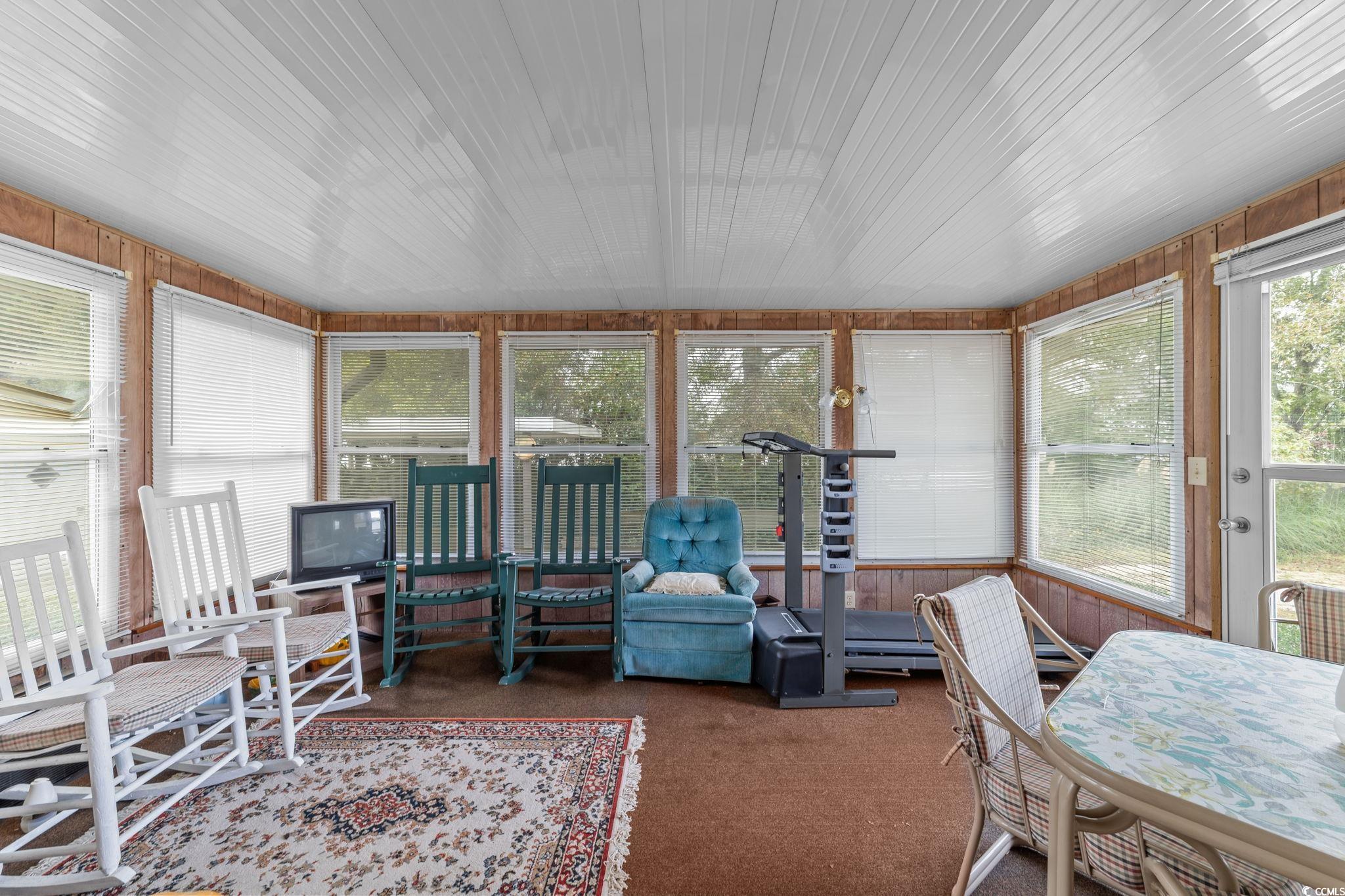 894 South Marlin Circle Murrells Inlet, SC 29576 - Photo 18 of 40 Sunroom / solarium with wooden walls, carpet flooring, and a baseboard radiator