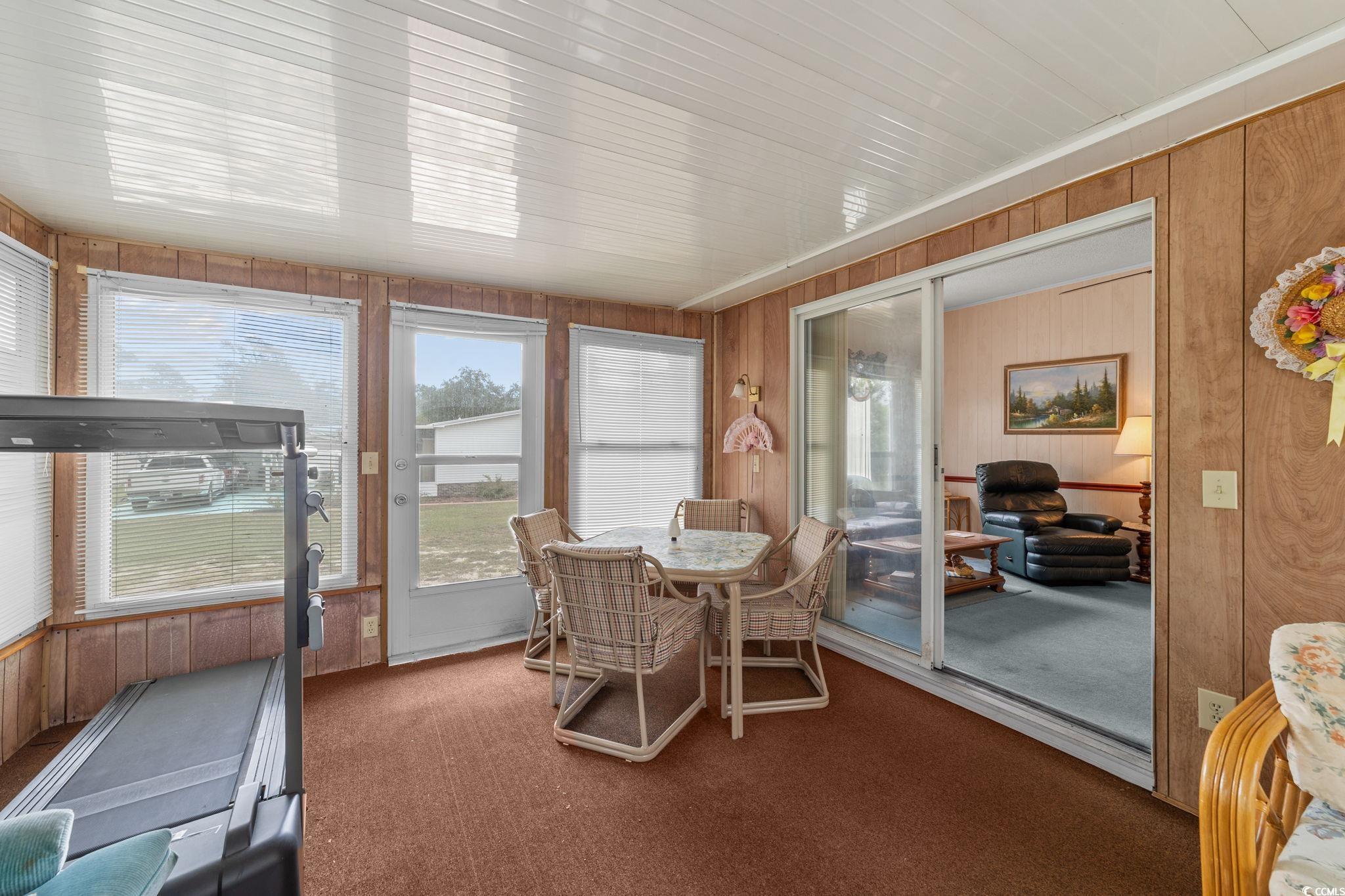 894 South Marlin Circle Murrells Inlet, SC 29576 - Photo 19 of 40 Sunroom / solarium featuring wood walls and carpet