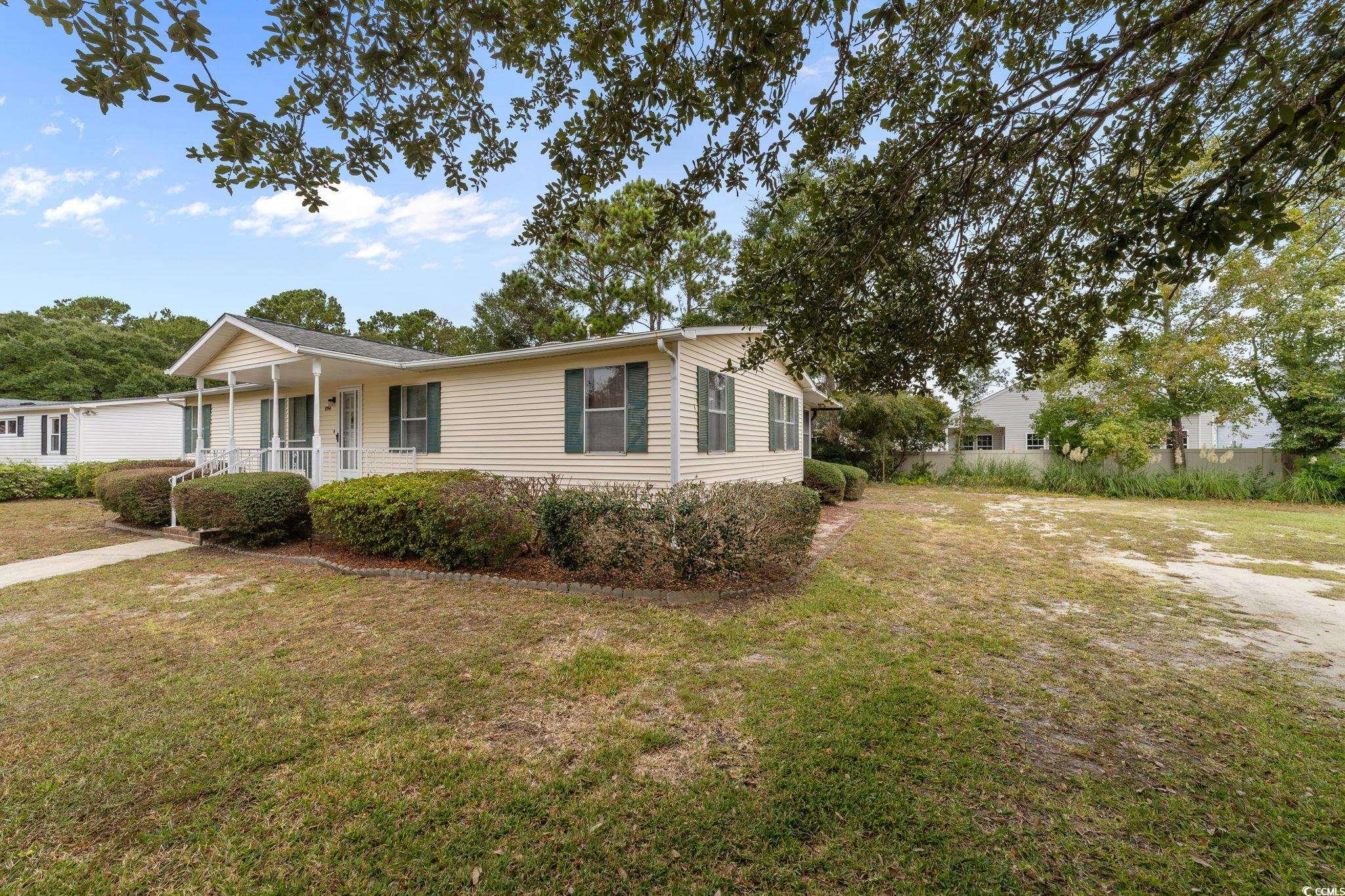 894 South Marlin Circle Murrells Inlet, SC 29576 - Photo 2 of 40 View of front facade featuring a porch and a front yard