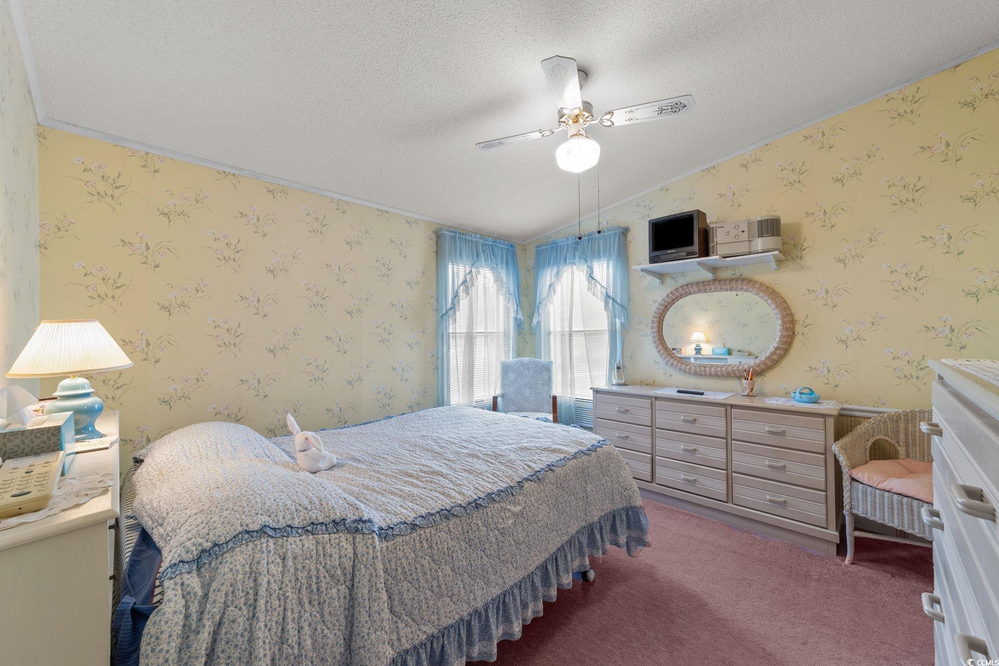 894 South Marlin Circle Murrells Inlet, SC 29576 - Photo 23 of 40 Bedroom featuring wallpapered walls, vaulted ceiling, a textured ceiling, carpet flooring, and ceiling fan