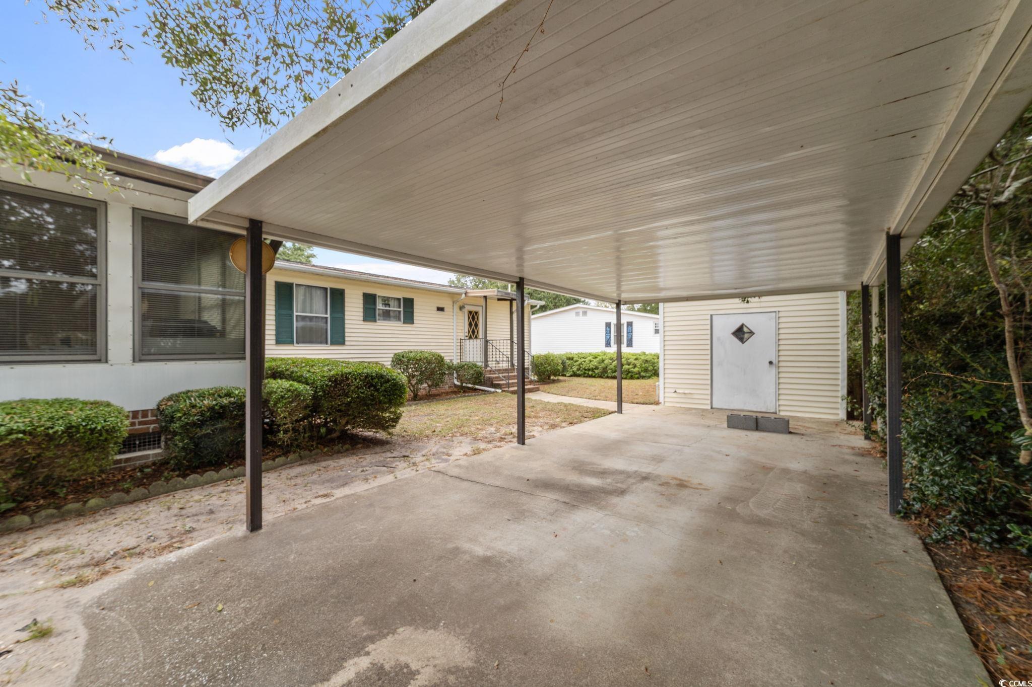 894 South Marlin Circle Murrells Inlet, SC 29576 - Photo 3 of 40 View of patio featuring a carport and a storage shed