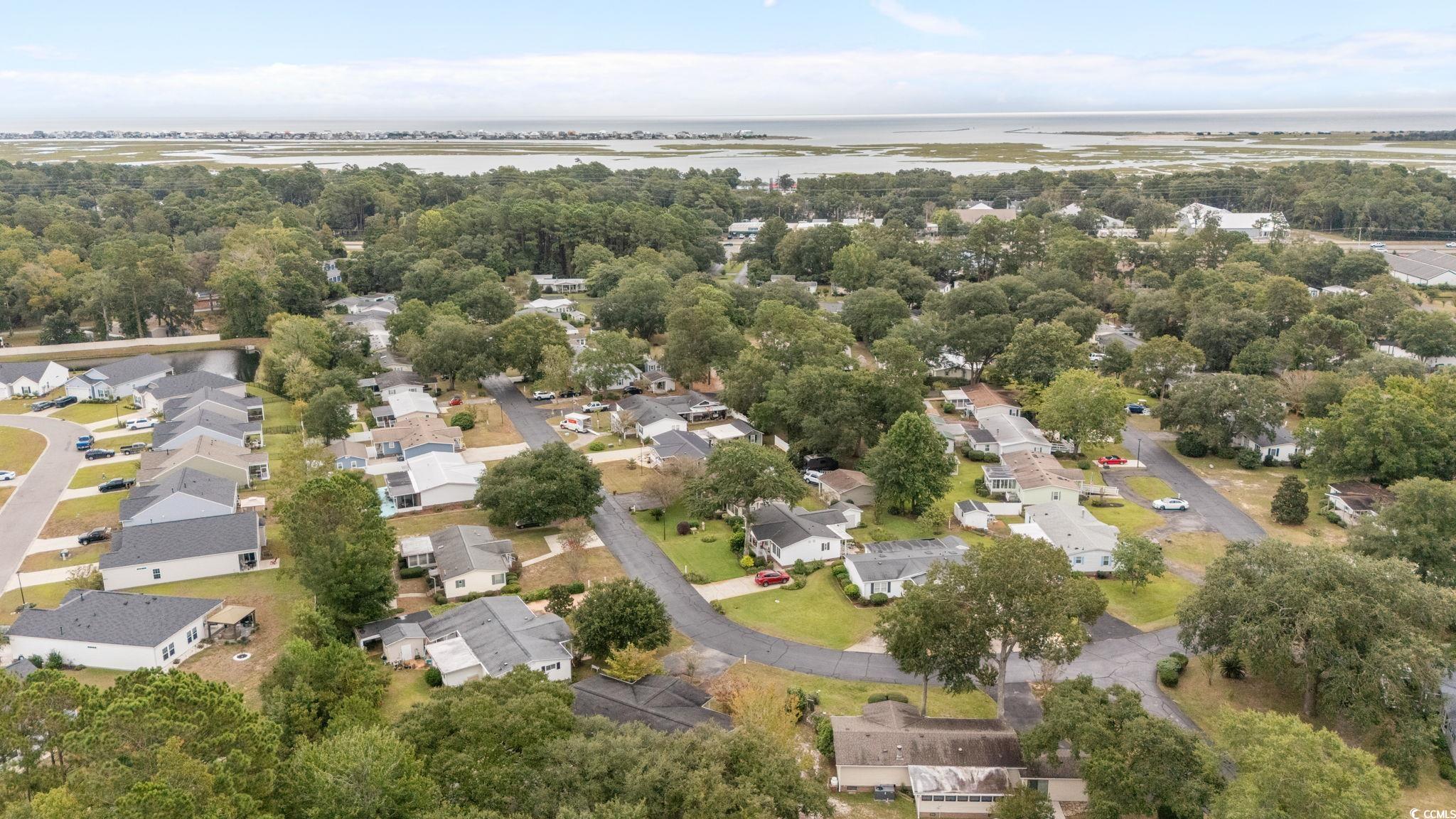 894 South Marlin Circle Murrells Inlet, SC 29576 - Photo 31 of 40 Aerial perspective of suburban area featuring a large body of water and a tree filled landscape
