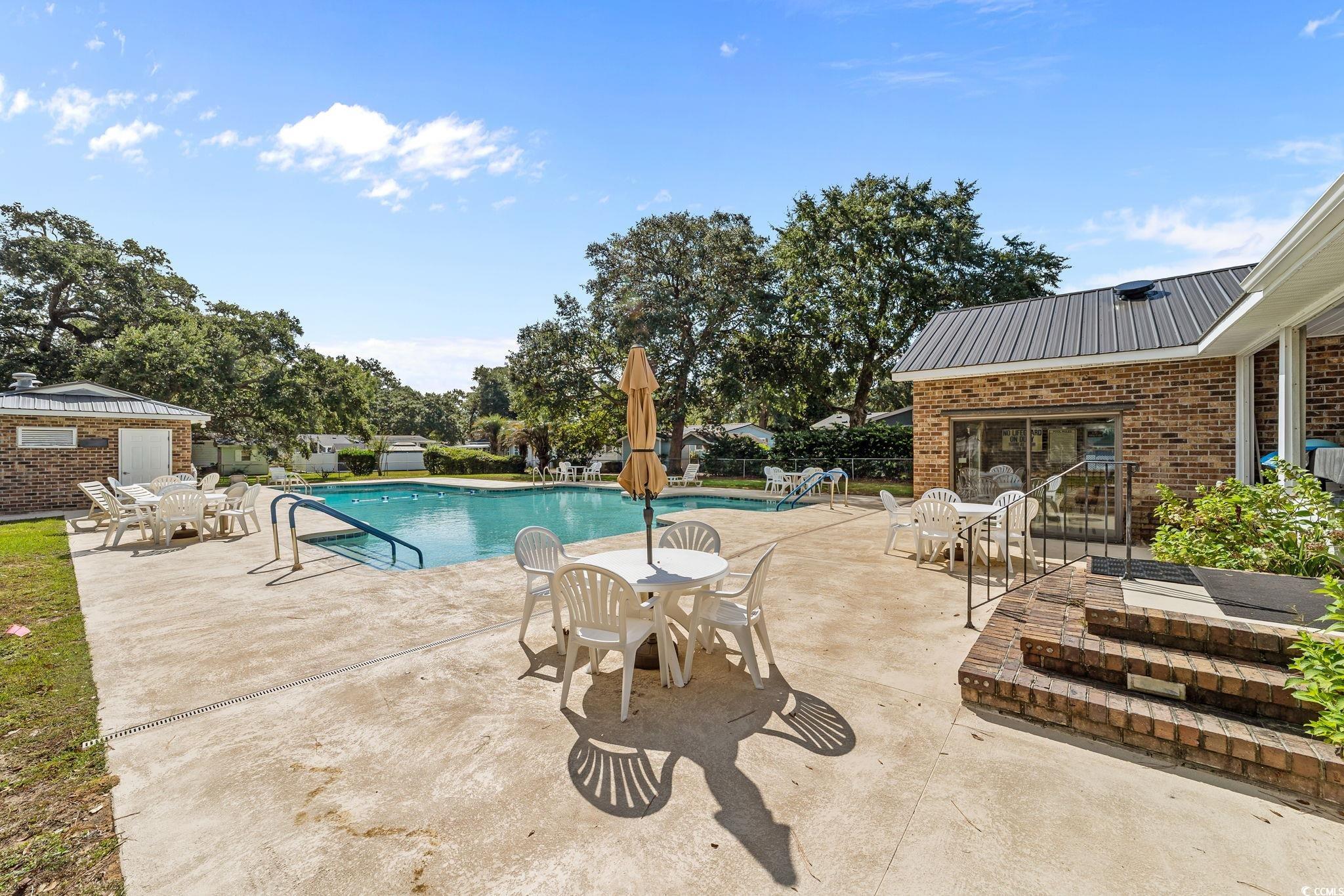 894 South Marlin Circle Murrells Inlet, SC 29576 - Photo 36 of 40 Community pool featuring a patio and outdoor dining area