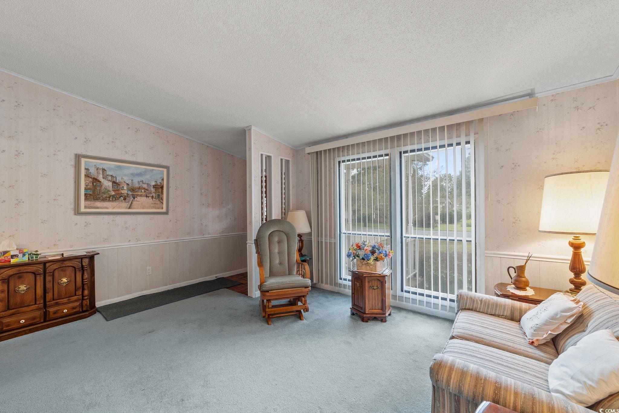 894 South Marlin Circle Murrells Inlet, SC 29576 - Photo 5 of 40 Sitting room featuring wallpapered walls, a wainscoted wall, a textured ceiling, and carpet