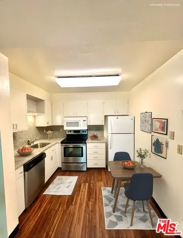 a kitchen with a cabinets and white appliances