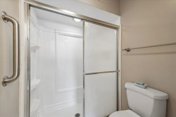 a bathroom with a toilet and a shower