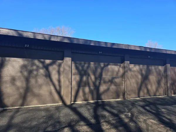a view of a yard with wooden fence