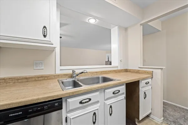 a view with granite countertop a sink and a stove