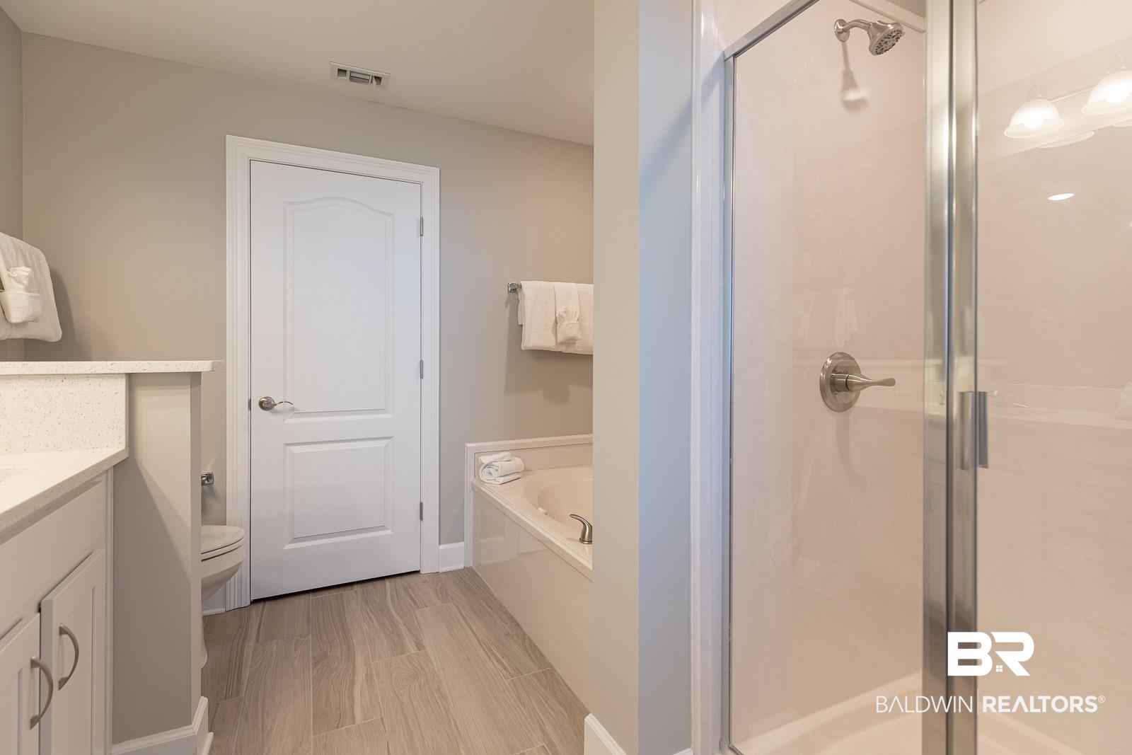 23008 Perdido Beach Boulevard, Unit 2003 Orange Beach, AL 36561 - Photo 11 of 35 Full bathroom with double vanity, toilet, and separate shower and tub